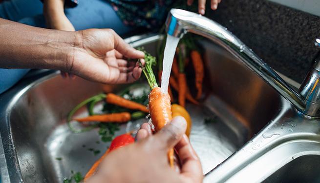Washing carrots in the sink