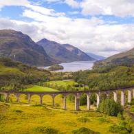 The old steam locomotive runs over the Glenfinnan Viaduct railway